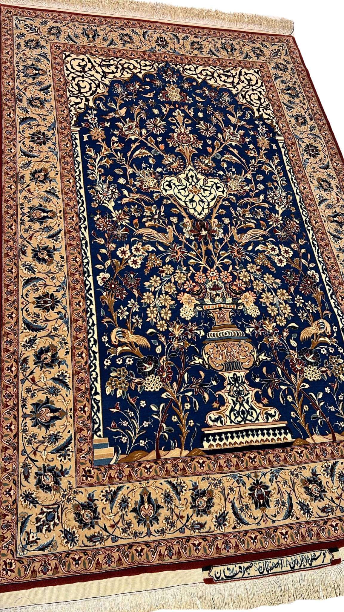"Close-up of the detailed floral patterns on a hand-knotted silk and wool Seirafian rug by Master Mohammad Ali Seirafian."